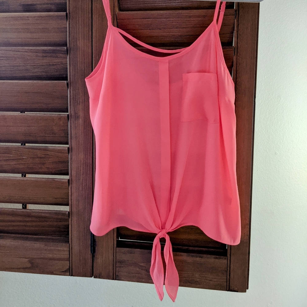 Candies sheer, loose fitting, bright pink tank top with a tie in the front.